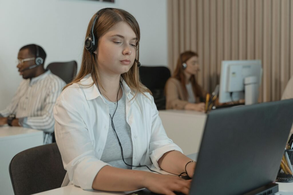 Multiracial call center employees focused on providing customer support with laptops.